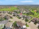 Aerial perspective showcasing a residential community with varied architectural styles and mature landscaping - 2423 Tegler Green, Edmonton, AB 