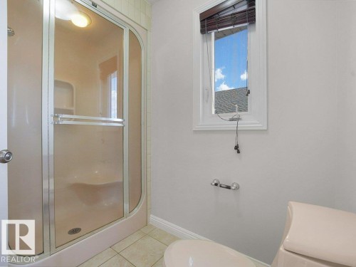 Enclosed shower with frosted glass panels and integrated lighting - 2423 Tegler Green, Edmonton, AB 