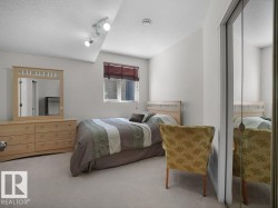 Bedroom featuring light-colored carpeting and white painted walls - 
