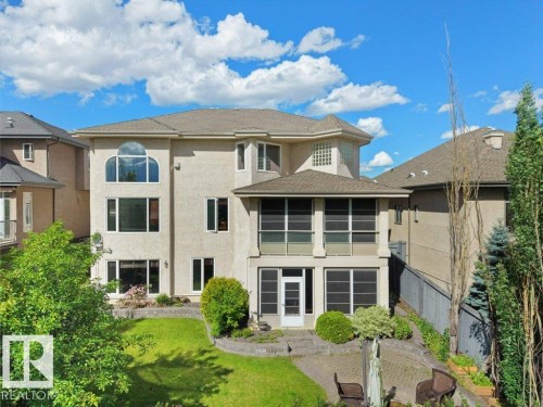 Stucco exterior featuring multiple window styles, including an arched top window - 2423 Tegler Green, Edmonton, AB 
