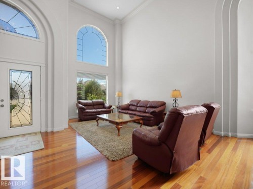 Two-story living area featuring a vaulted ceiling and wood-finish flooring - 2423 Tegler Green, Edmonton, AB 