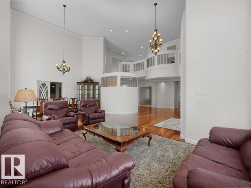 Grand living area featuring soaring ceilings and polished wood-finish flooring - 2423 Tegler Green, Edmonton, AB 