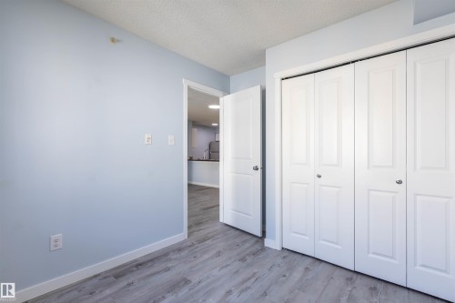 Light blue wall paint complementing wood-finish flooring - 403 25 Element Dr, St. Albert, AB - Indoor Photo Showing Other Room