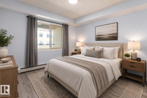 Spacious bedroom featuring light wood-finish flooring, a neutral upholstered headboard, and a large window with privacy drapes - 403 25 Element Dr, St. Albert, AB - Indoor Photo Showing Bedroom
