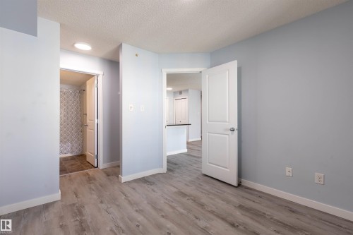 Light blue walls with white trim and wood-finish flooring throughout - 403 25 Element Dr, St. Albert, AB - Indoor Photo Showing Other Room