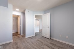 Light blue walls with white trim and wood-finish flooring throughout - 