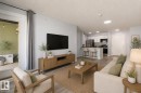 Open-concept living area featuring wood-finish flooring, a patio door, and recessed lighting - 403 25 Element Dr, St. Albert, AB  - Indoor Photo Showing Living Room 