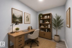 Dedicated office space featuring light wood-finish flooring, a built-in light wood desk with drawers, and a matching light wood open-shelf bookcase with lower cabinet storage - 