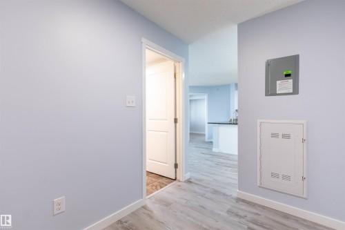 Light blue painted walls with white trim and wood-finish flooring - 403 25 Element Dr, St. Albert, AB - Indoor Photo Showing Other Room