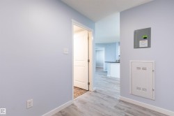 Light blue painted walls with white trim and wood-finish flooring - 