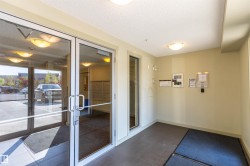 Secure entry with full-light glass doors and durable tile flooring - 