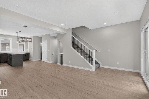 Open-concept living space with wood-finish flooring - 33 11910 35 Avenue, Edmonton, AB 