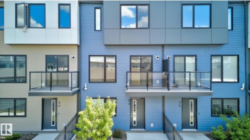 Contemporary multi-level townhome exteriors featuring horizontal siding and paneling - #33 11910 35 Av Sw, Edmonton, AB - Outdoor