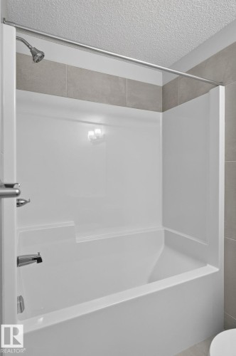 Contemporary vanity with a light-toned countertop, undermount sink, and brushed nickel faucet - 33 11910 35 Avenue, Edmonton, AB 