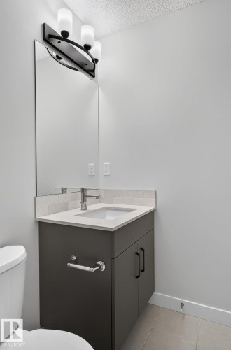 Light-filled interior space featuring neutral wall paint, white trim, and gray carpet - 33 11910 35 Avenue, Edmonton, AB 