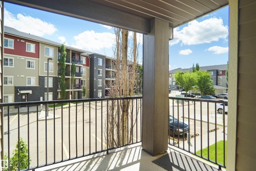 Balcony featuring a black metal railing and a textured ceiling - 215 1070 Mcconachie Blvd, Edmonton, AB 