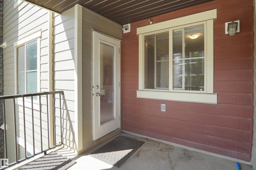 Exterior balcony featuring a concrete floor and black metal railing - 215 1070 Mcconachie Blvd, Edmonton, AB 