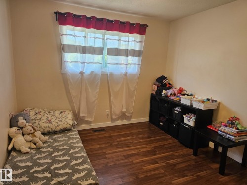 Wood-finish flooring provides a durable surface throughout this room - 4304 121 Avenue Nw, Edmonton, AB - Indoor
