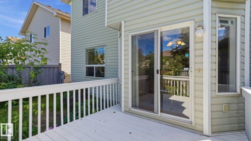 Exterior deck featuring white railings and wood-finish flooring - 3591 Mclean Crescent, Edmonton, AB 