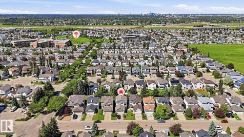 Aerial perspective showcasing a residential neighborhood with detached homes, mature trees, and well-defined streets - 3591 Mclean Crescent, Edmonton, AB 