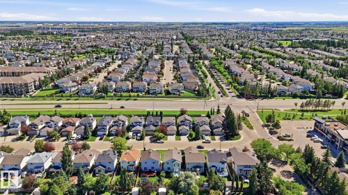 Expansive aerial perspective showcasing a developed residential area with numerous single-family homes, mature landscaping, and an organized street grid - 3591 Mclean Crescent, Edmonton, AB 