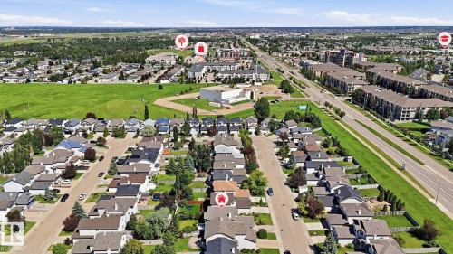 Aerial perspective showcasing a residential neighborhood with detached homes, green spaces, and a parallel thoroughfare - 3591 Mclean Crescent, Edmonton, AB 