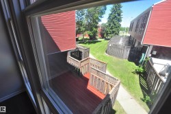 Private outdoor deck with wood-finish flooring and lattice railing - 