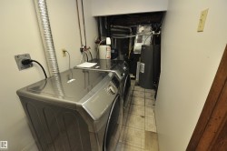 Dedicated laundry area featuring a washer and dryer, utility connections, and vinyl tile flooring - 