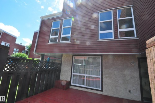 Private exterior deck with painted wood flooring and a privacy fence - 617 Millbourne Road E, Edmonton, AB 