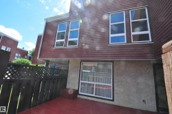 Private exterior deck with painted wood flooring and a privacy fence - 
