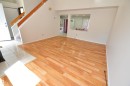 Hardwood flooring with a gloss finish, white tile entry, white baseboards, and a built-in architectural cutout - 617 Millbourne Road E, Edmonton, AB 