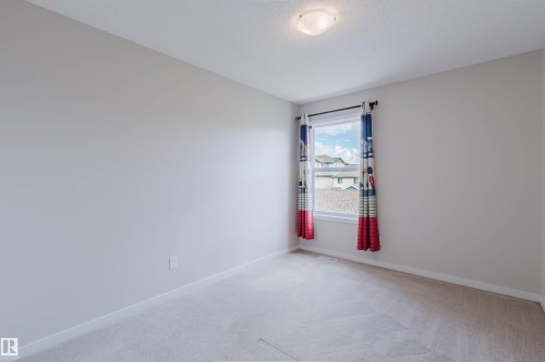 Neutral wall finishes with white baseboards and light-toned carpeting - 636 Mcdonough Link Link, Edmonton, AB 