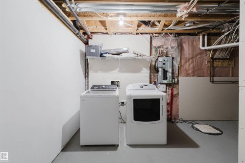 Utility area featuring a top-load washing machine and a front-load dryer - 636 Mcdonough Link Link, Edmonton, AB 