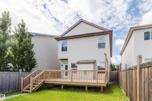 Expansive backyard featuring a large wooden deck with full balustrade, a grass lawn, and wood privacy fencing - 636 Mcdonough Link Link, Edmonton, AB 