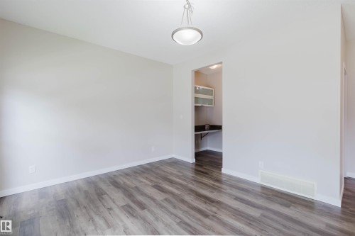Spacious room featuring wood-finish flooring and neutral wall tones - 636 Mcdonough Link Link, Edmonton, AB 