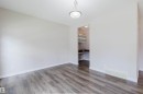 Spacious room featuring wood-finish flooring and neutral wall tones - 636 Mcdonough Link Link, Edmonton, AB 