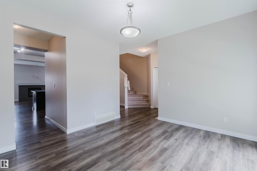 Spacious interior with wood-finish flooring, neutral wall tones, and recessed lighting - 636 Mcdonough Link Link, Edmonton, AB 