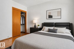 Bedroom featuring hardwood flooring and white walls - 