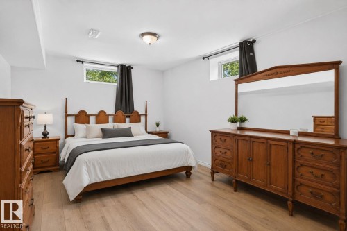 Bedroom featuring light wood-finish flooring and white painted walls - 12238 48 Street, Edmonton, AB 