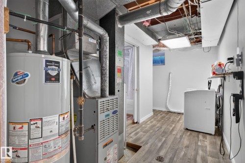 Dedicated utility space featuring a water heater, furnace, and washer - 12238 48 Street, Edmonton, AB 