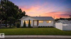White siding exterior with a dark shingle roof - 