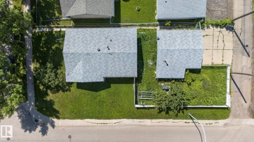 Aerial perspective of a property featuring a gray shingle roof and a spacious green lawn - 12238 48 Street, Edmonton, AB 
