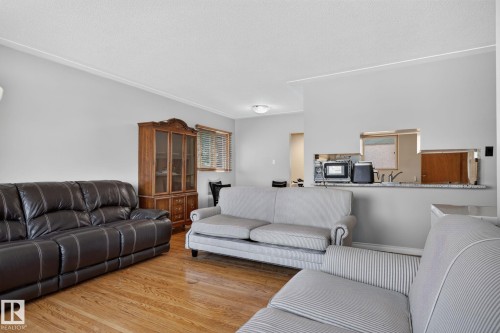 Living area featuring hardwood flooring and light gray wall paint - 12238 48 Street, Edmonton, AB 