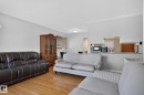 Living area featuring hardwood flooring and light gray wall paint - 12238 48 Street, Edmonton, AB 