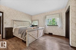 Hardwood-finish flooring complements the room's light-toned wallpaper - 