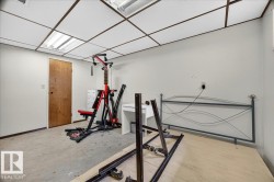 Neutral white walls with a drop ceiling featuring recessed fluorescent lighting - 