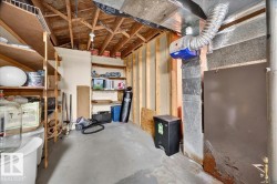 Utility space featuring exposed wood ceiling joists and concrete flooring - 