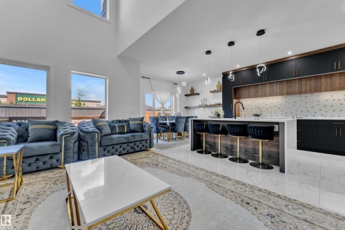 Open-concept living space featuring a modern kitchen and dining area - 16816 49 Street, Edmonton, AB 