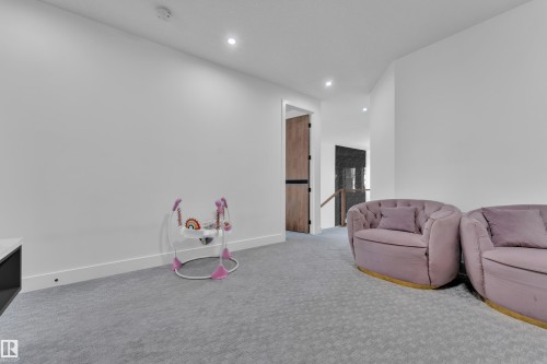 Carpeted room with recessed lighting, white walls, and white baseboards - 16816 49 Street, Edmonton, AB 