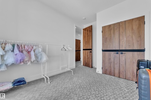 Contemporary wood-finish doors with matte black hardware - 16816 49 Street, Edmonton, AB 